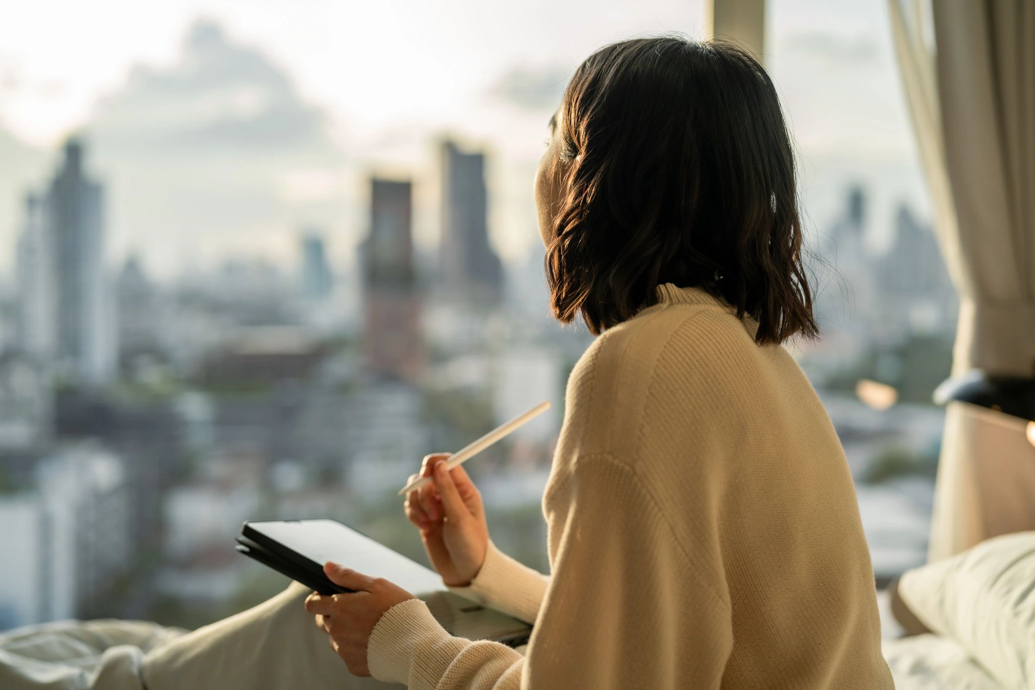 Woman journaling on a tablet in a calm, reflective moment